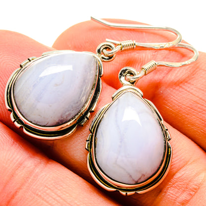 Teardrop blue stone earrings with silver-tone hooks and beaded bezel