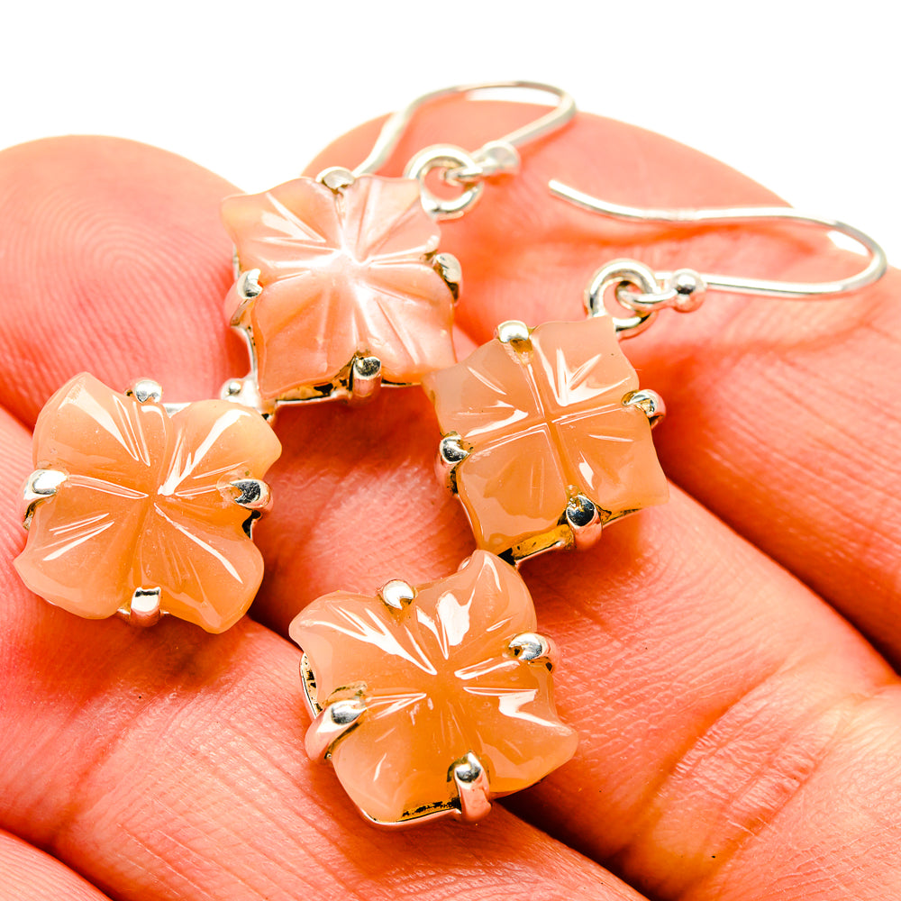 Orange flower carnelian drop earrings, 925 silver hooks, close-up of dangling charms
