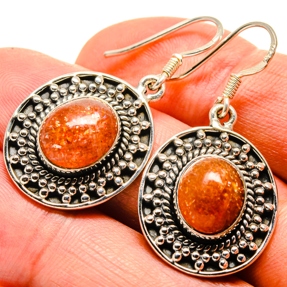 Round sterling silver earrings with orange sunstone cabochon and beaded border
