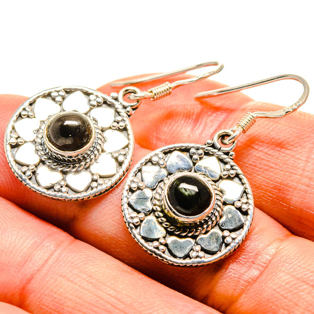 Sterling silver diopside earrings close-up with round black-green stone and heart-like accents