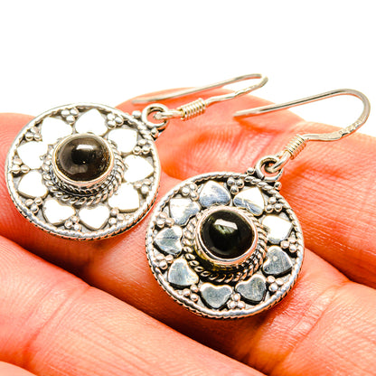 Sterling silver diopside earrings close-up with round black-green stone and heart-like accents