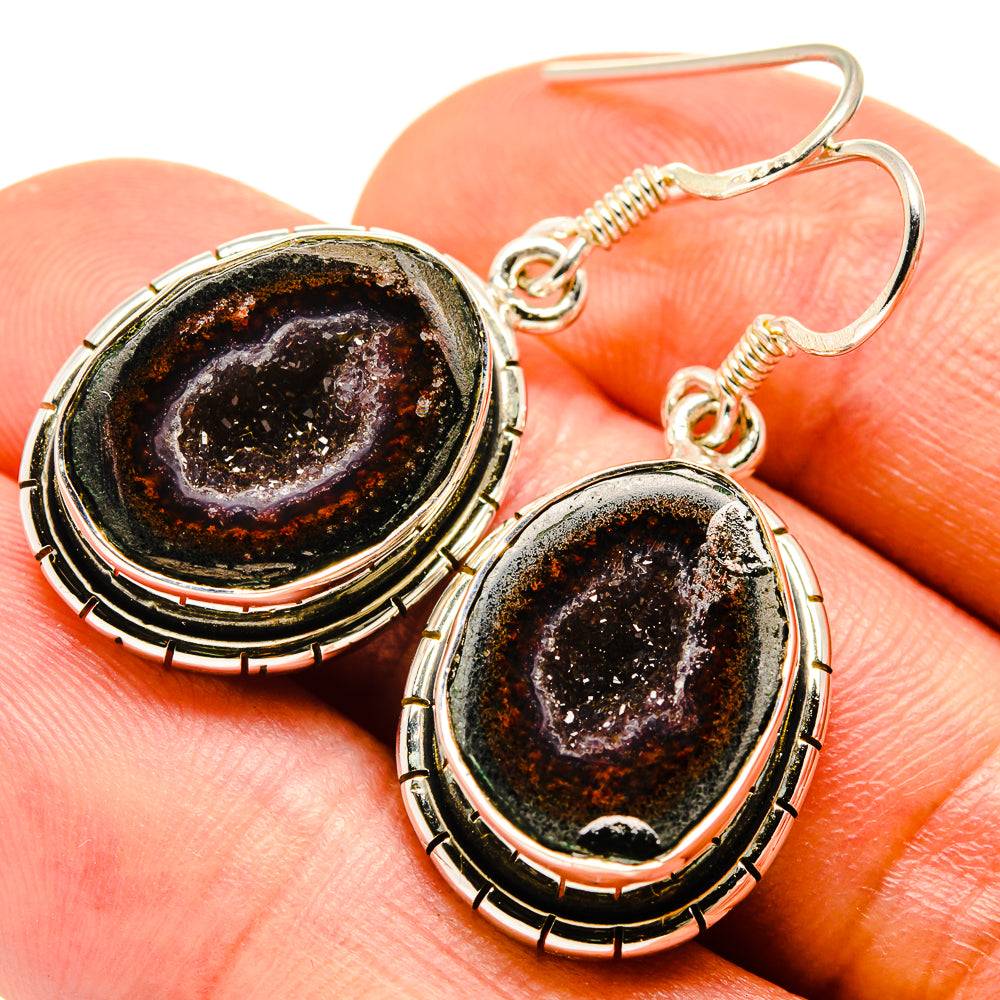 Gold-tone oval drop earrings with dark druzy geode centers on fishhook settings