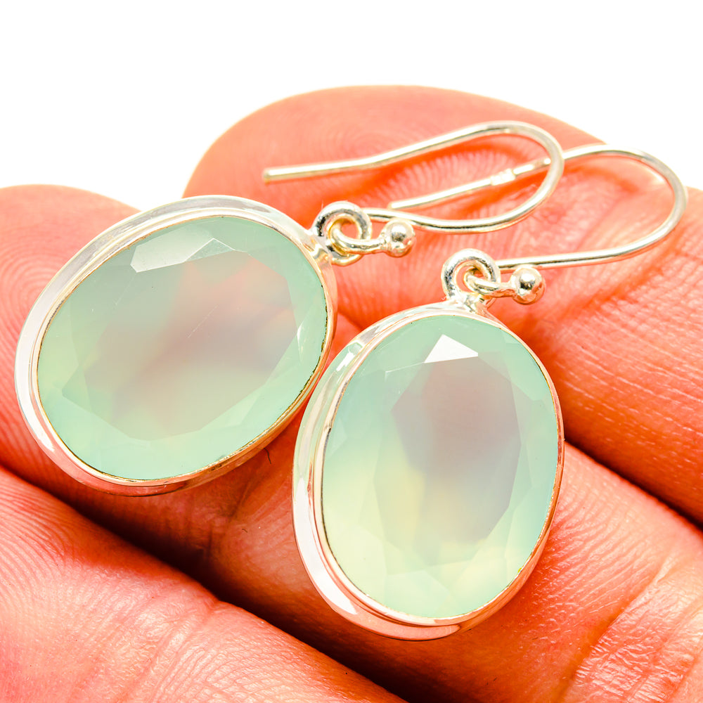 Oval drop earrings with aqua green cabochon stones and gold-tone French hooks
