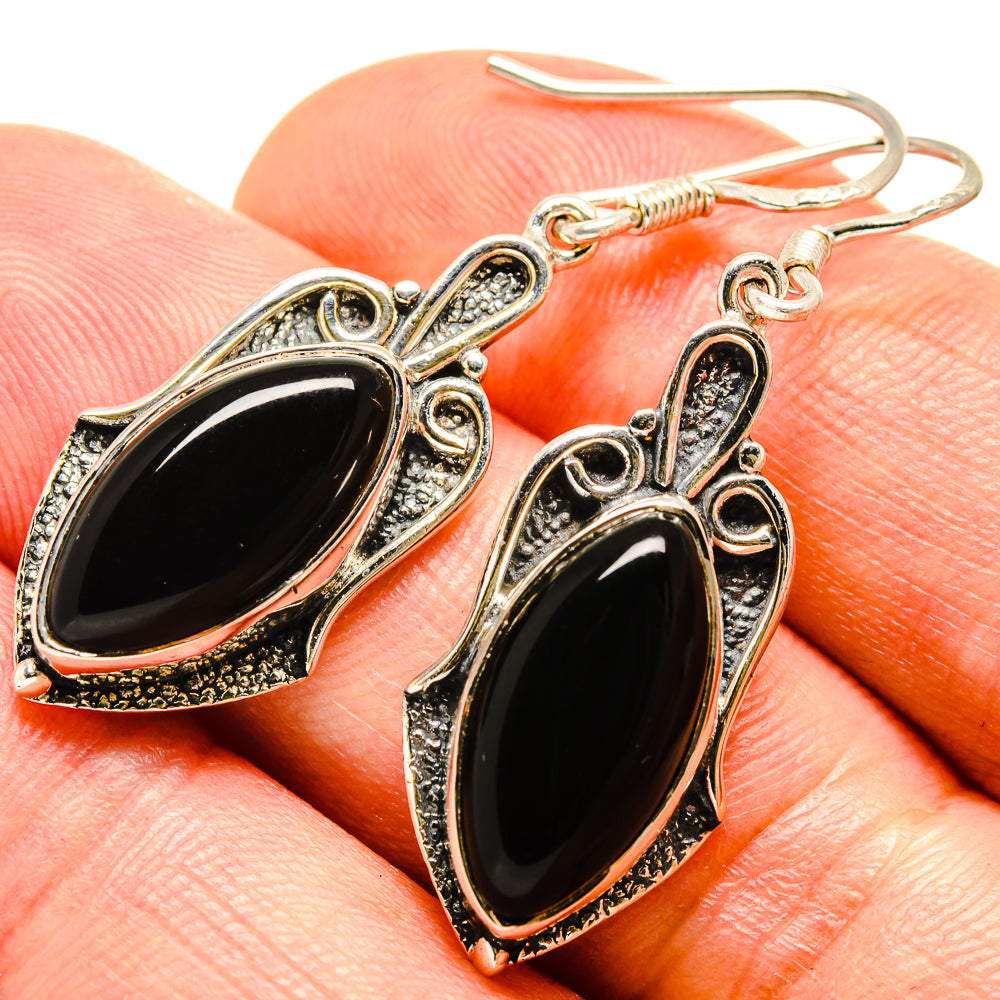 Onyx oval dangle earrings with textured silver-tone bezel and fishhook closure