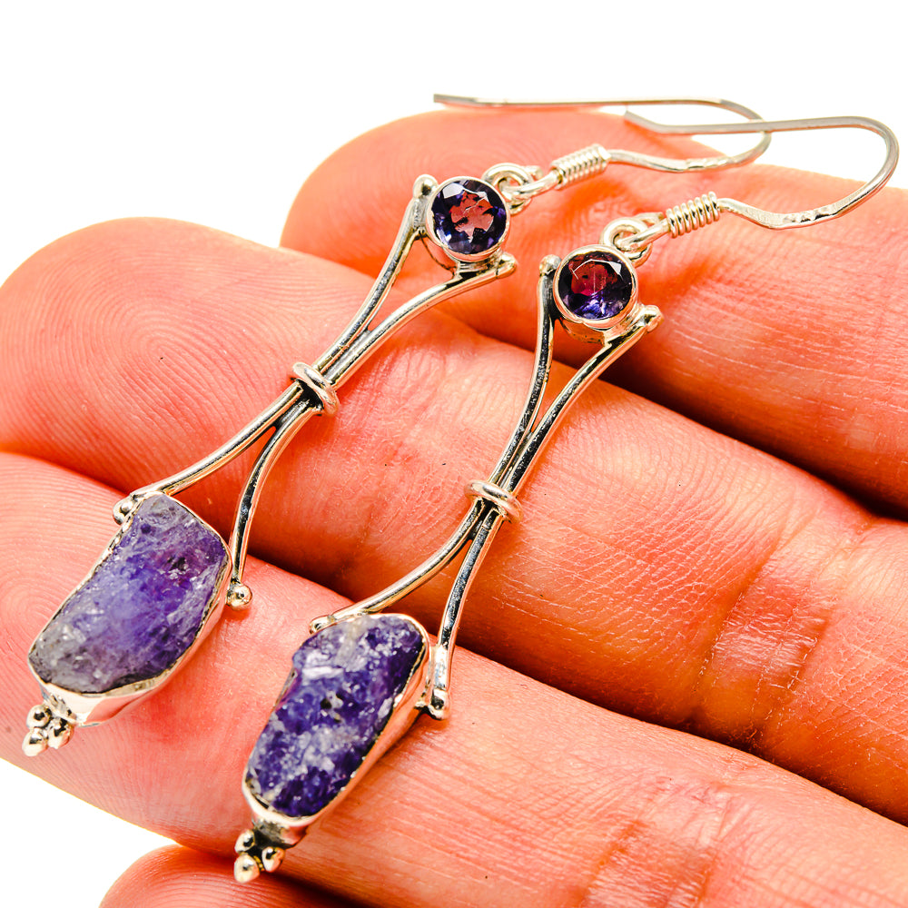 Rough tanzanite drop earrings close-up with purple textured stones on silver hooks