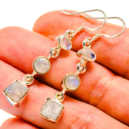 Dangling earrings with rough opalescent moonstone and gold-tone oval and square charms