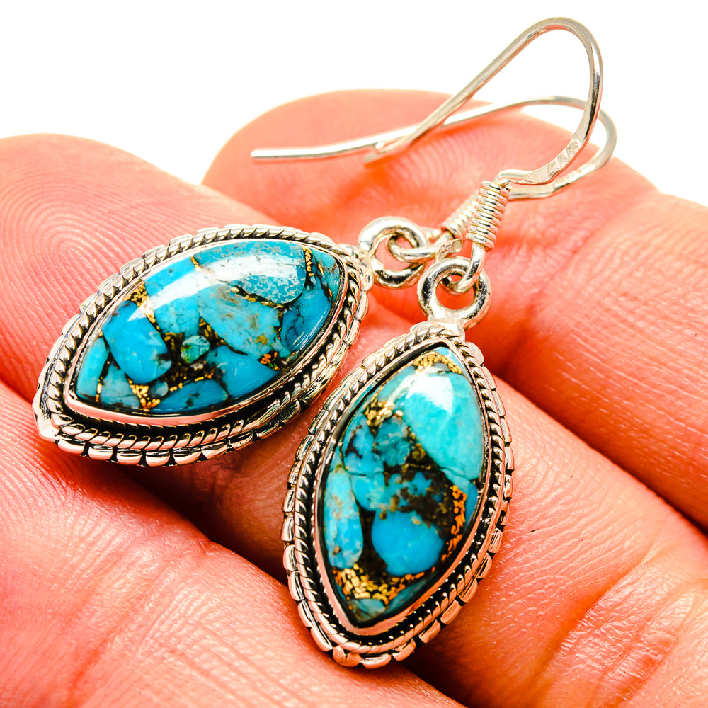 Turquoise oval dangle earrings with sterling-silver rope border and hook backs.