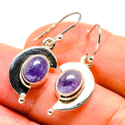 Sterling silver tanzanite drop earrings, close-up oval purple stones with dark bezel