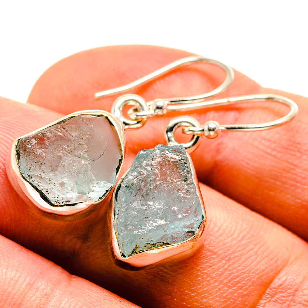 Rough aquamarine earrings with bezel-set raw stones and small hoop hooks, silver-tone