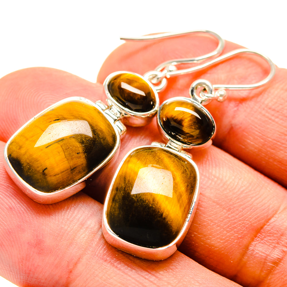 Honey-gold tiger eye drop earrings with teardrop stones and silver hooks