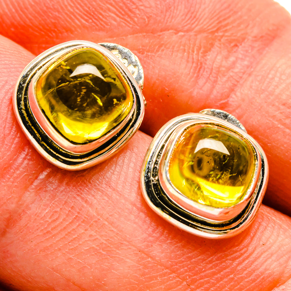 Citrine stud earring close-up with yellow oval gemstone in silver bezel
