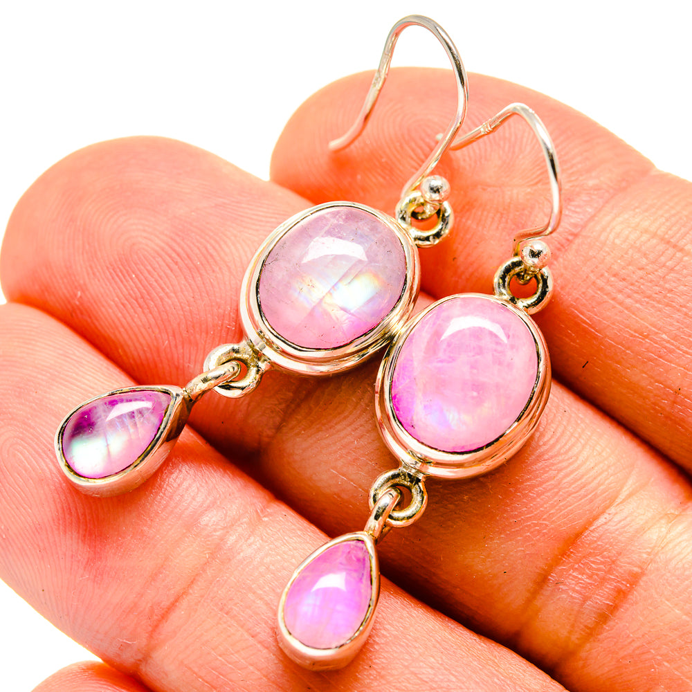 Pink moonstone drop earrings close-up: oval top stones with teardrop dangles on hooks