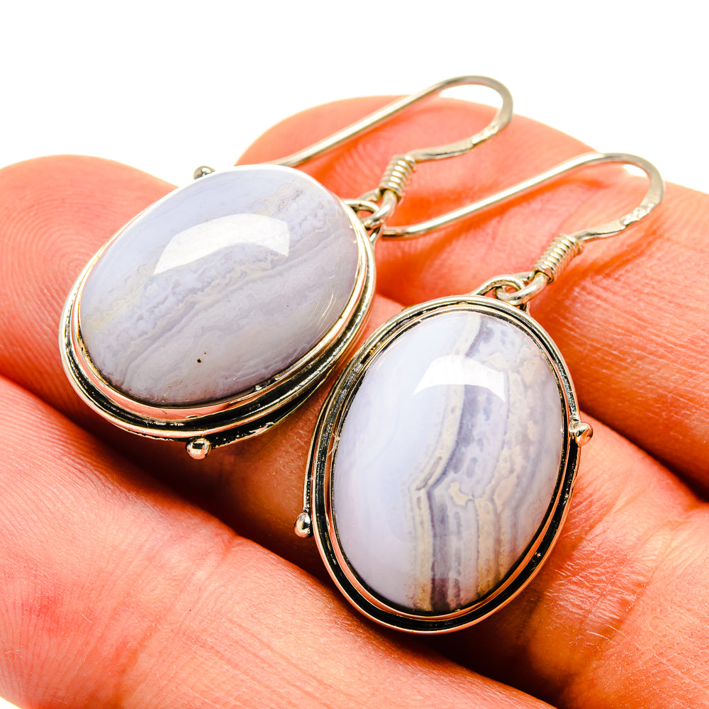 Oval blue lace agate earrings with gold-tone frames and curved fishhook