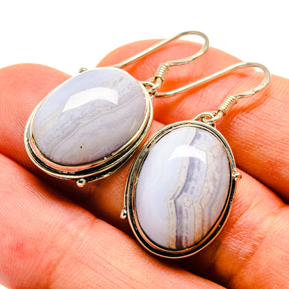Oval blue lace agate earrings with gold-tone frames and curved fishhook