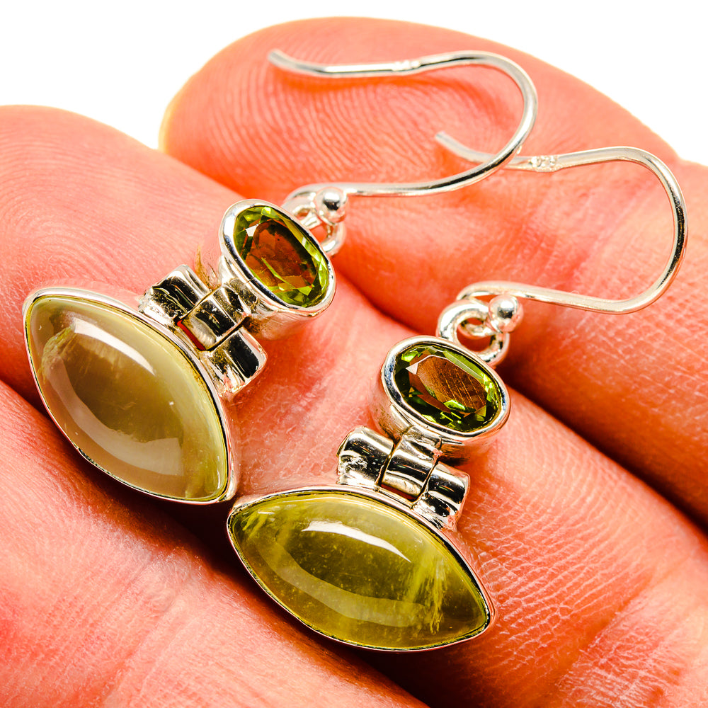 Silver drop earrings with oval peridot green gemstones and round stud tops
