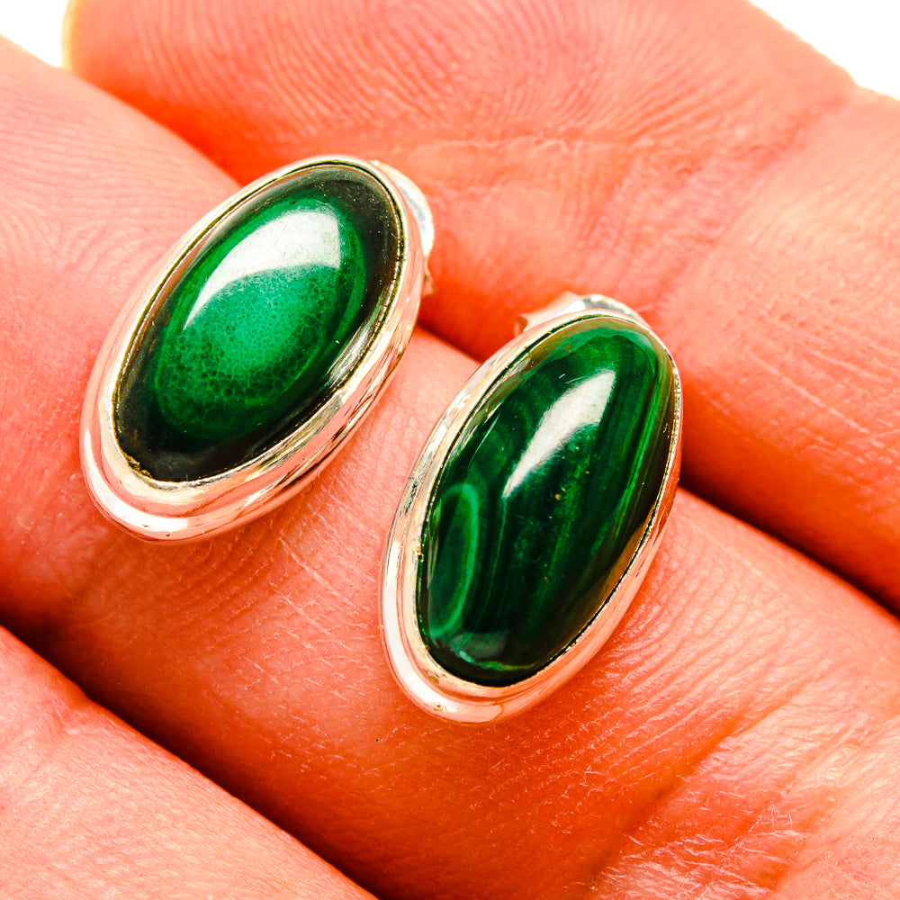 Close-up oval malachite earrings with green cabochon stones on sterling silver