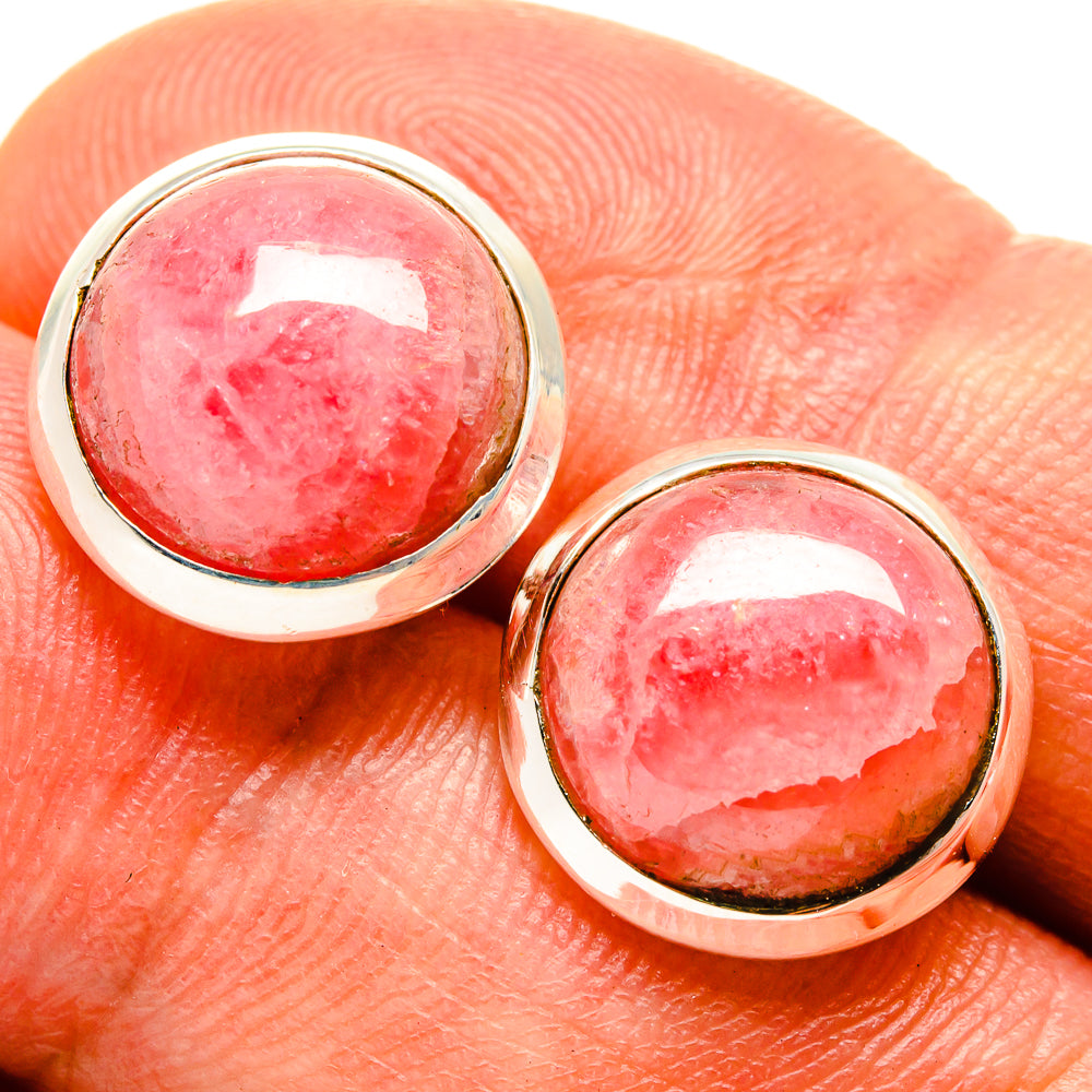 Oval rhodochrosite earrings with pink gemstone bezels and silver hook backs.
