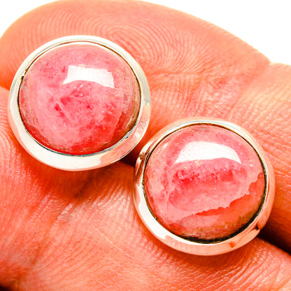 Oval rhodochrosite earrings with pink gemstone bezels and silver hook backs.