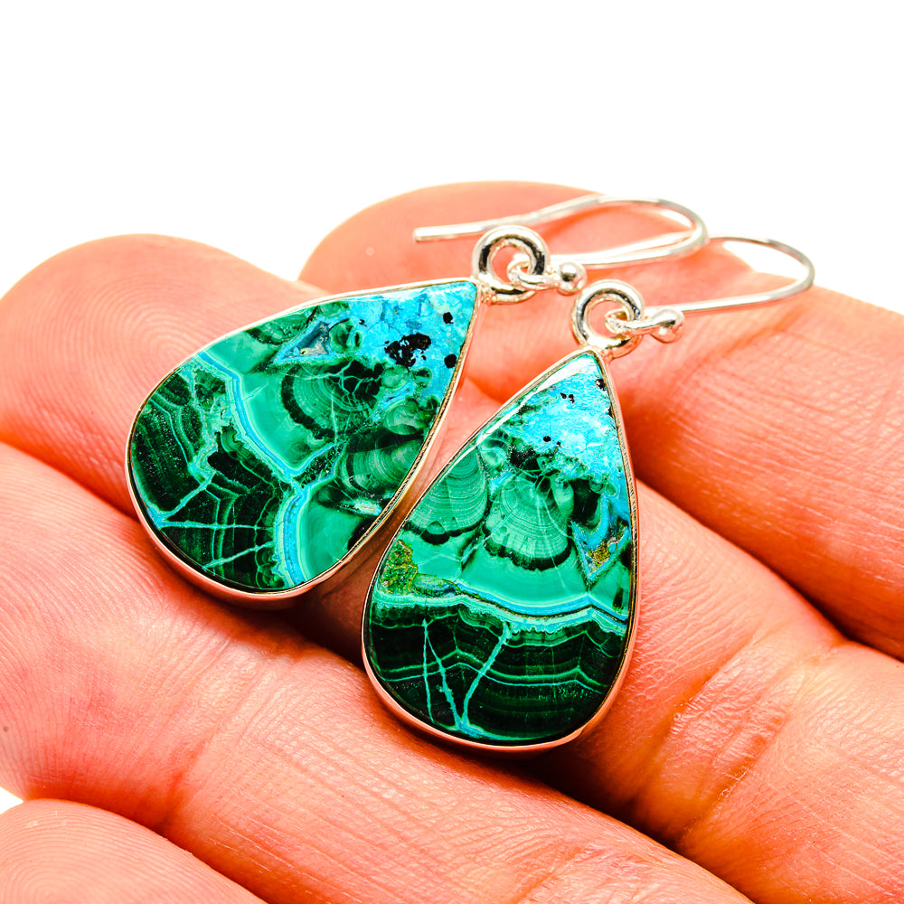 Teardrop gemstone earrings with gold hooks, turquoise and green on fingertip