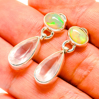 Silver and gold dangle earrings with opal-like round stones and pink teardrop drops