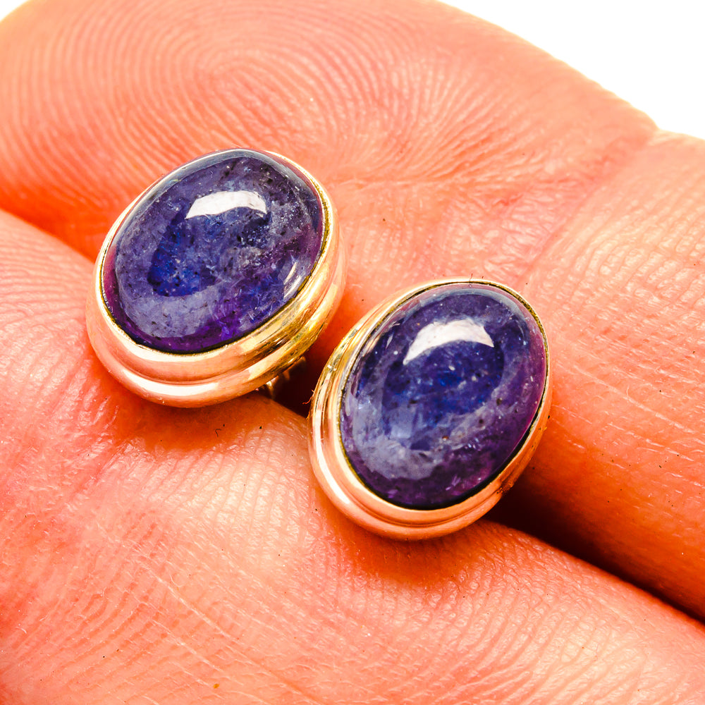 Oval natural tanzanite earrings with purple-blue cabochon stones in gold-tone bezel