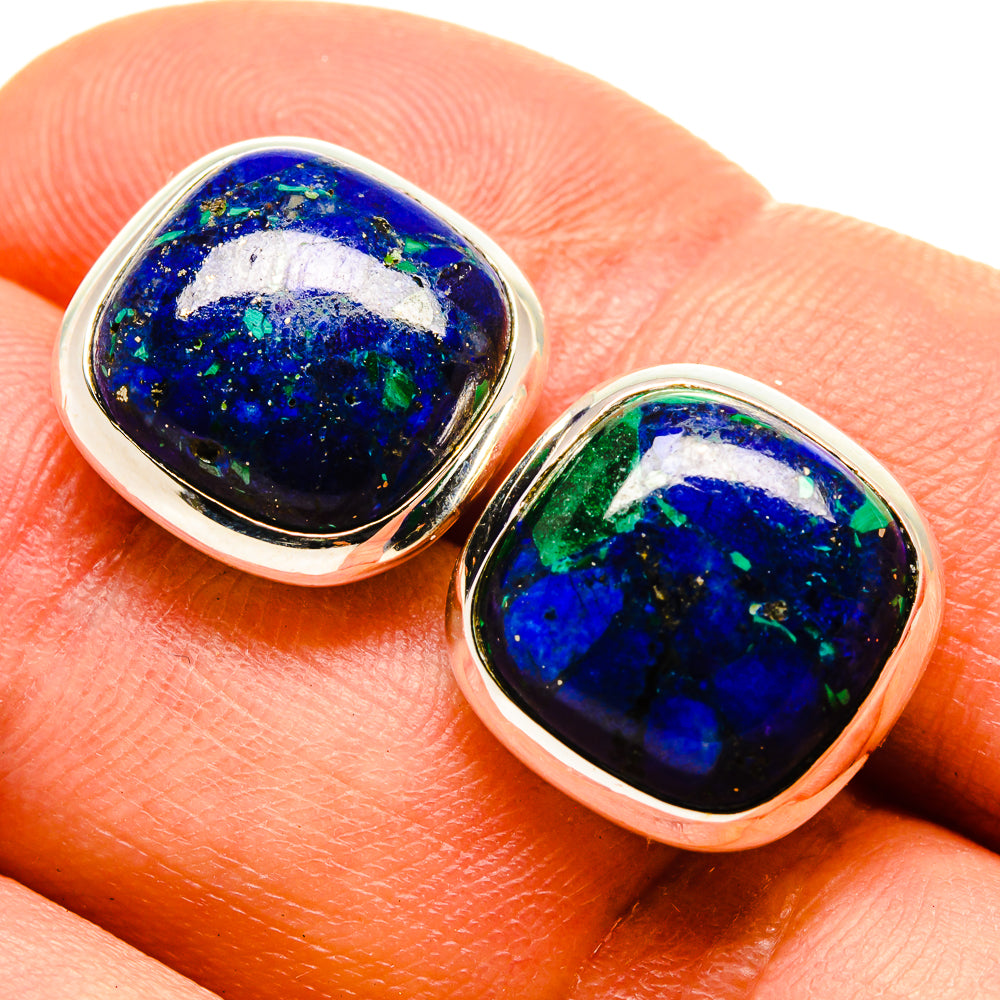 Close-up of oval azurite-style cabochon stud earrings, blue with green flecks, silver bezel