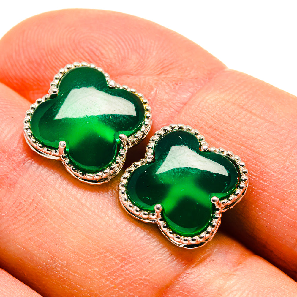 Green onyx quatrefoil stud earrings with textured silver bezel, close-up