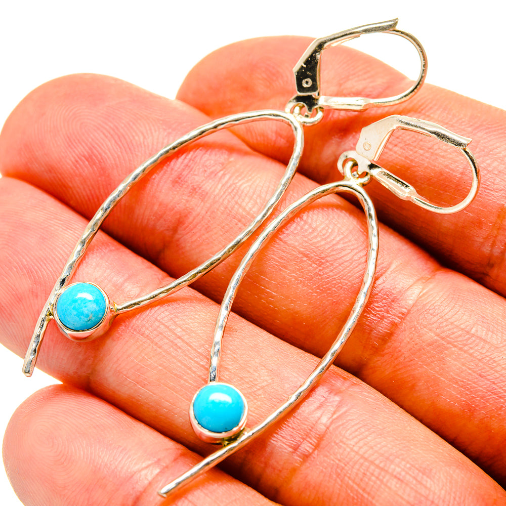 Larimar stone earrings with turquoise round beads on silver-tone hooks, close-up