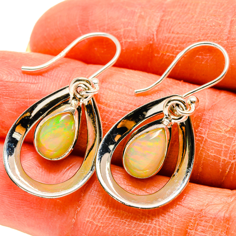 Sterling silver teardrop opal earrings with iridescent teardrop center and hook backs