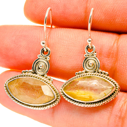 Rutilated quartz drop earrings on gold-tone hoops, oval stones with ornate bezel