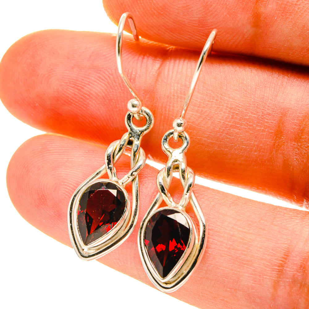 925 sterling silver garnet teardrop earrings with faceted red stone and hook backs.