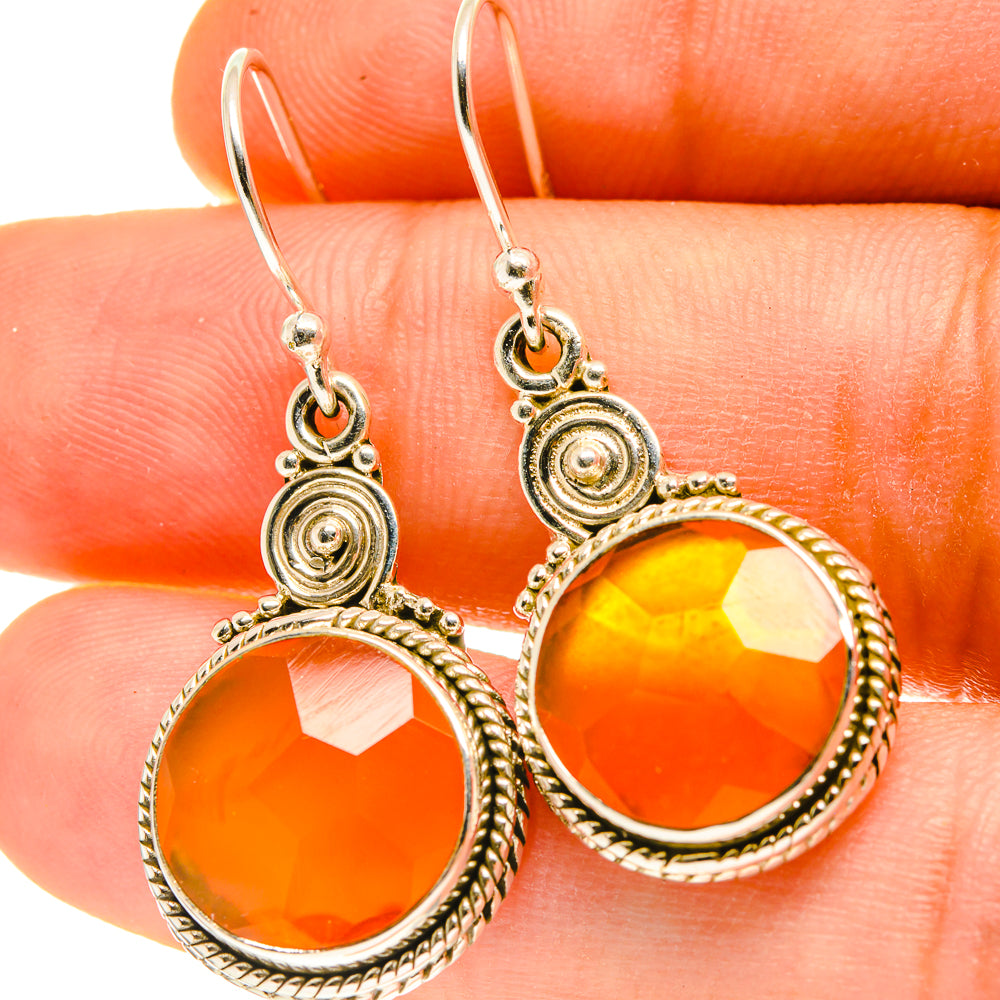 Carnelian drop earrings with round orange stones and ornate sterling silver frames