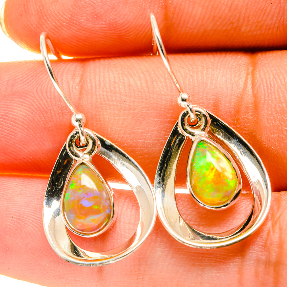 Teardrop opal earrings in polished sterling silver with green-orange teardrop stones