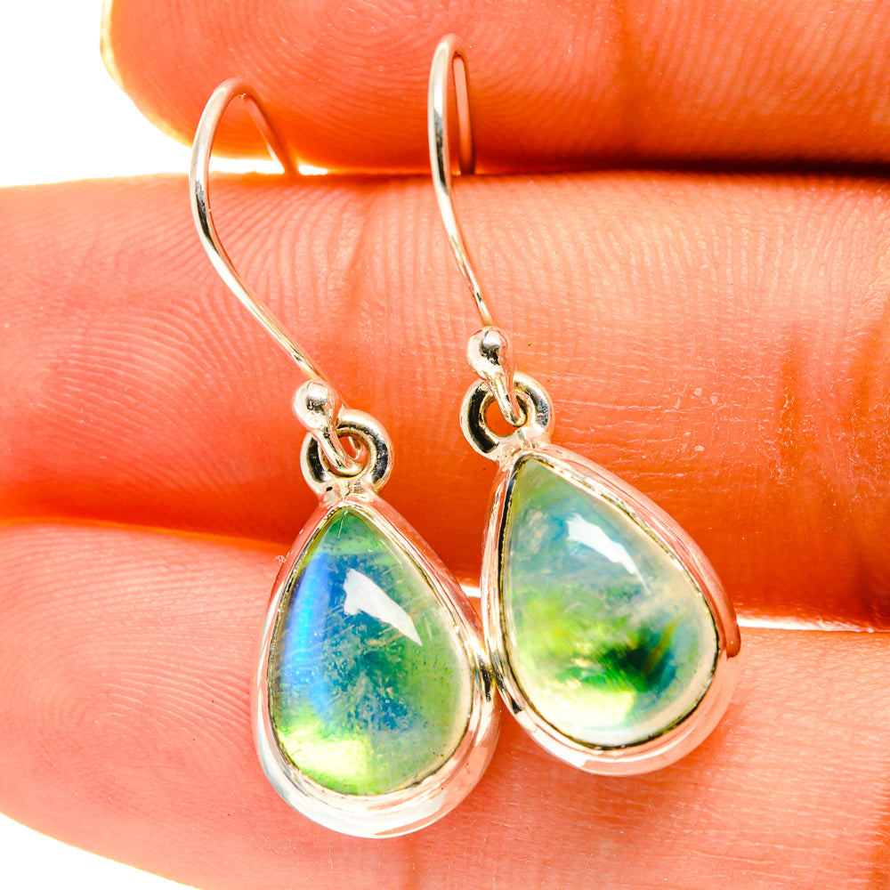 Teardrop moonstone earrings with green-blue stone and silver loop hooks, close-up