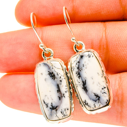 Dendritic opal drop earrings with oval white stones and silver hooks, dendrite veining.