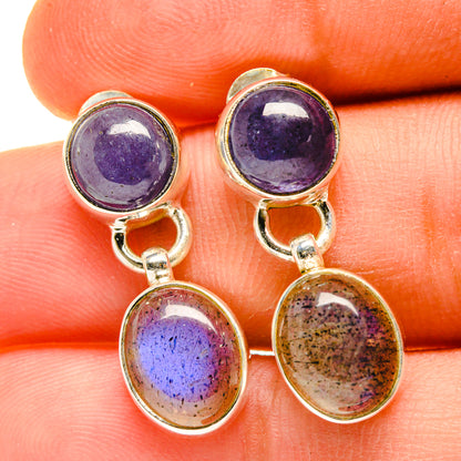 Close-up sterling silver earrings with purple round stones and gold speckled round dangles