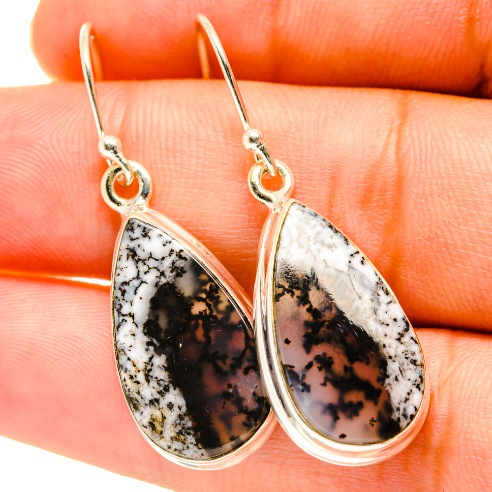 Teardrop dendritic opal earrings with silver hooks and pear-shaped stone, black and white.