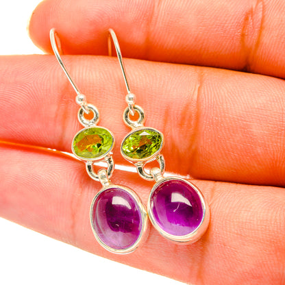 Silver-tone drop earrings with green peridot and purple amethyst oval stones