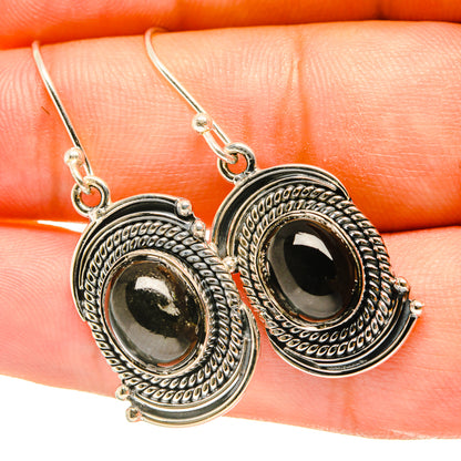 Sterling silver star diopside drop earrings with oval black cabochon and ornate bezel