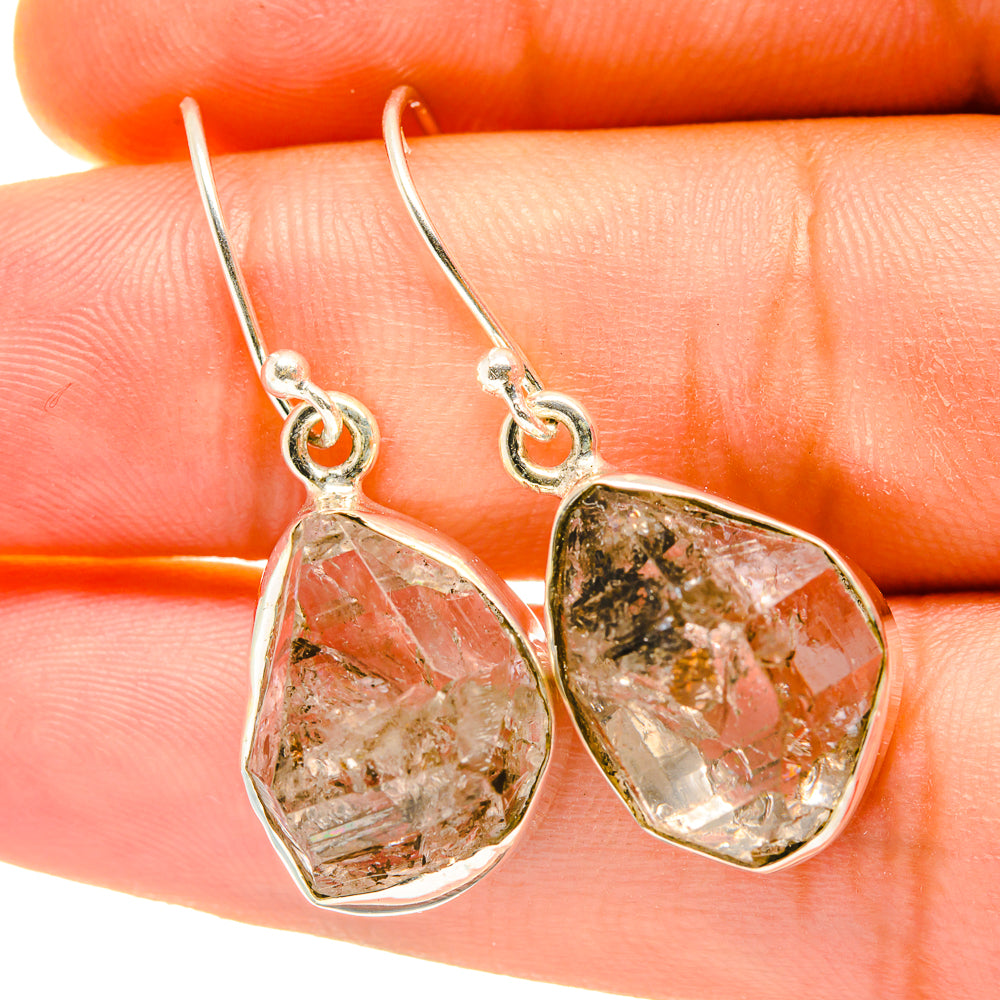 Faceted teardrop gemstone earrings with small metal loops and dangling hooks