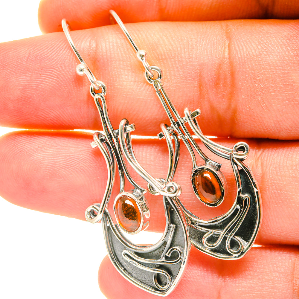 Silver-tone amber drop earrings with swirl filigree and orange cabochon, lever hooks