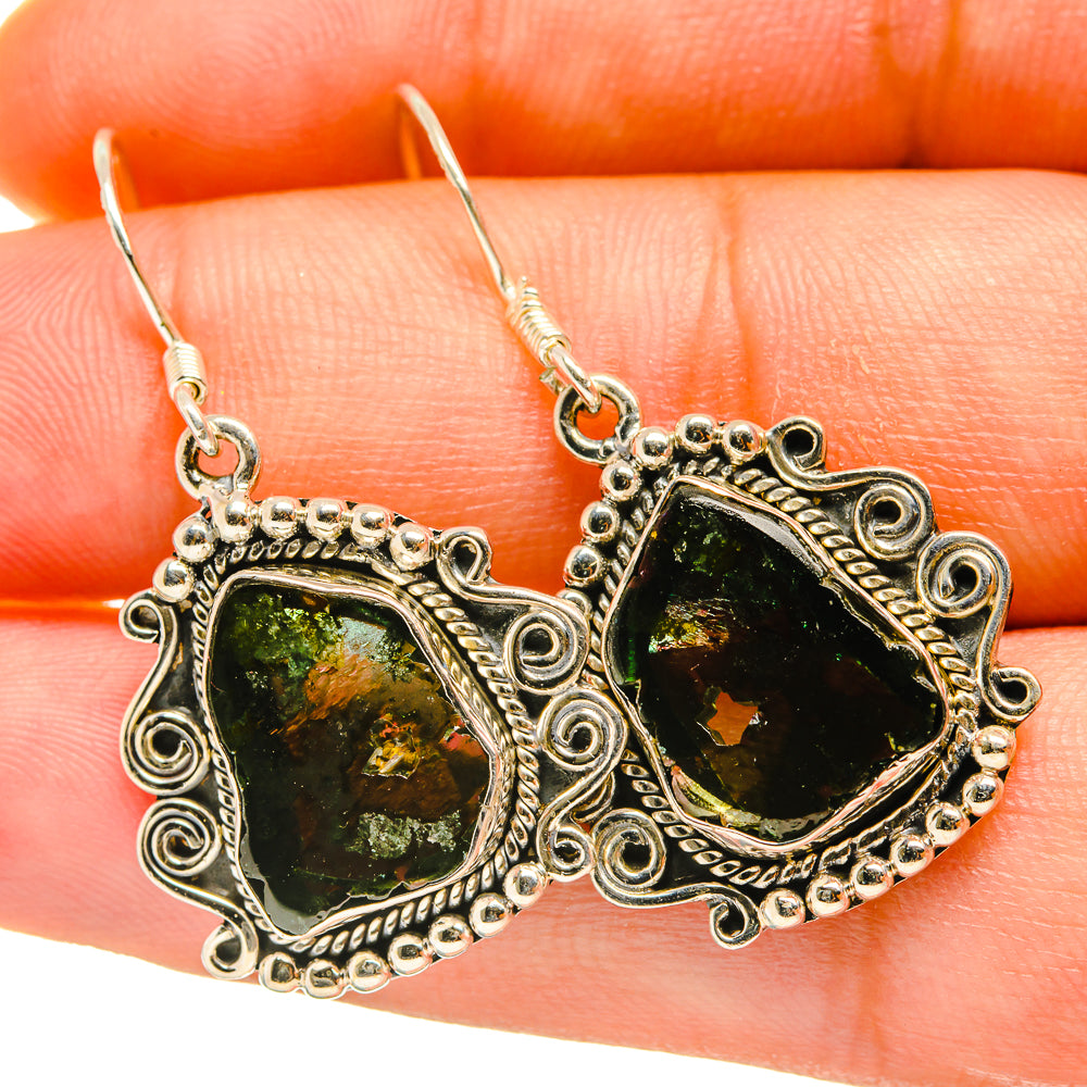 Sterling silver teardrop earrings with rough dark green tourmaline and ornate filigree setting
