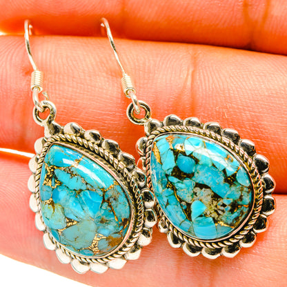 Oval turquoise stone drop earrings with silver-tone twisted bezel and hook backs