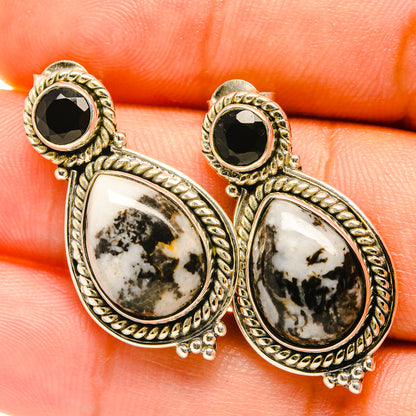 Gold-tone drop earrings with black round tops and white-black dendritic agate teardrops