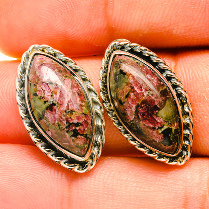 Oval eudialyte earrings with detailed silver-tone bezel and speckled red-green stone