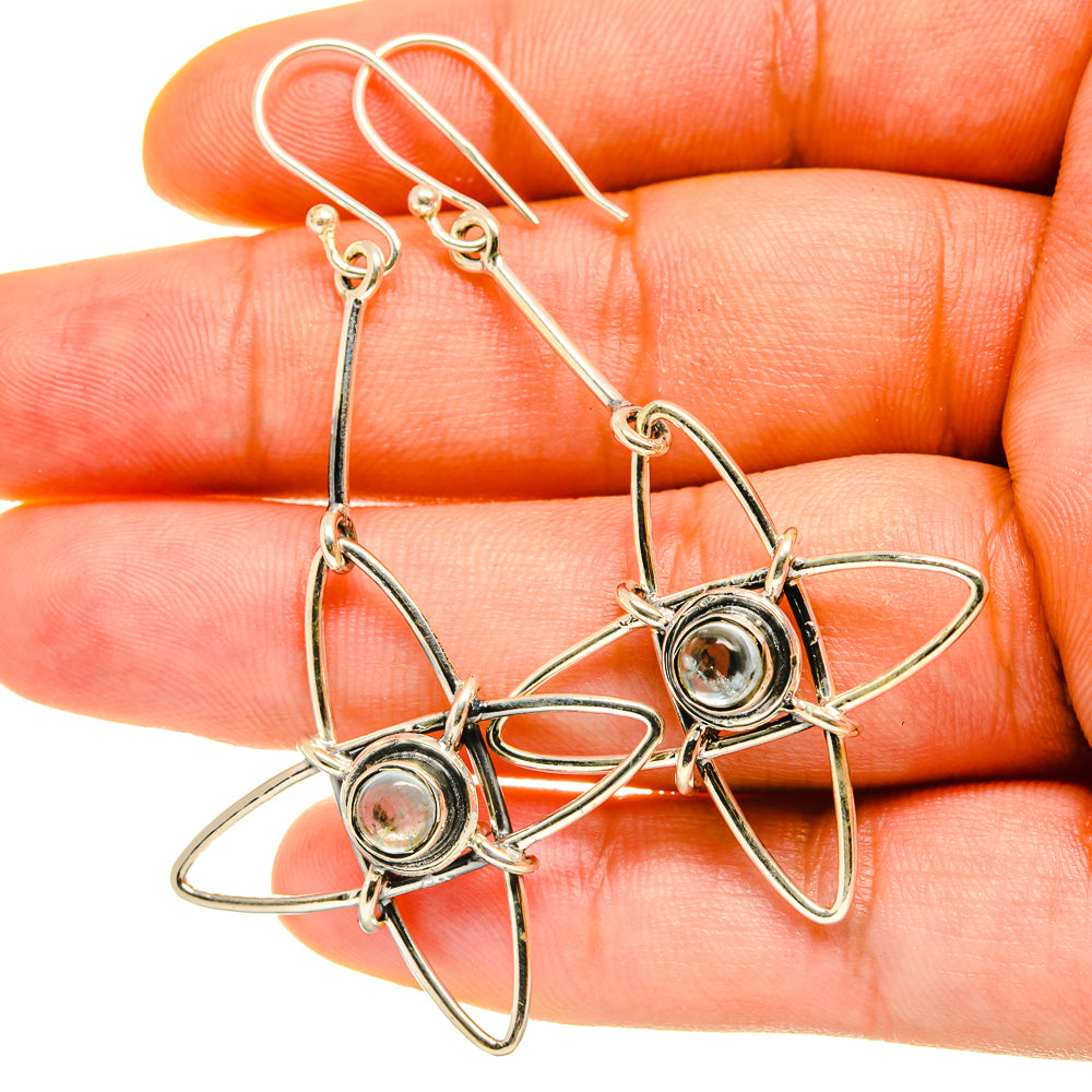 Sterling silver blue topaz circular studs with curved star-wire dangling drops