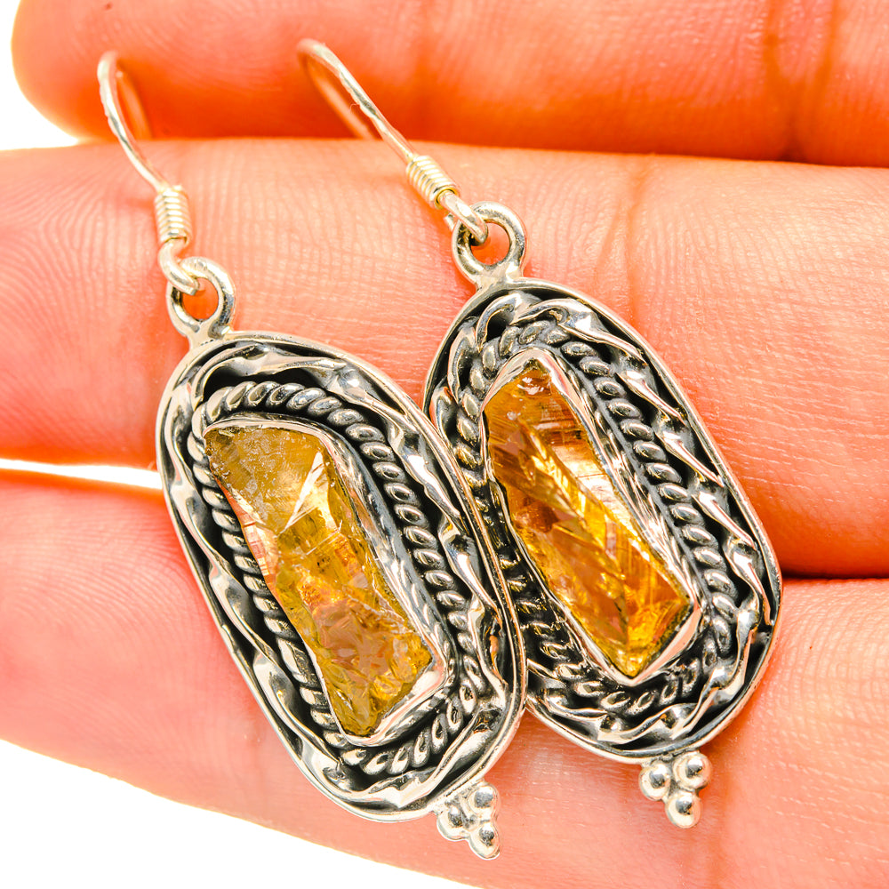 Sterling silver drop earrings with rough amber-yellow citrine stones in ornate bezel