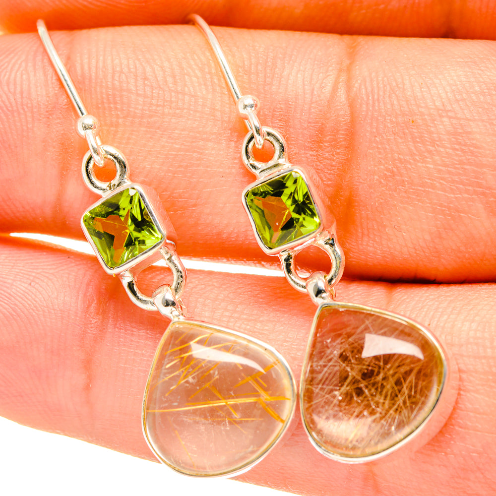 Sterling silver drop earrings with faceted green square stones and clear teardrop accents