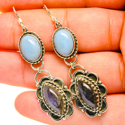 Gold-tone oval blue gemstone drop earrings with dark purple/green teardrop charms