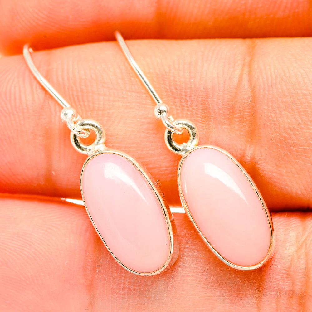 Pink opal earrings with glossy oval stones and gold-tone fishhook backs